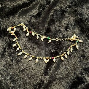 Ankle bracelet. Gold toned. Dangling pearls with multi colored rhinestones